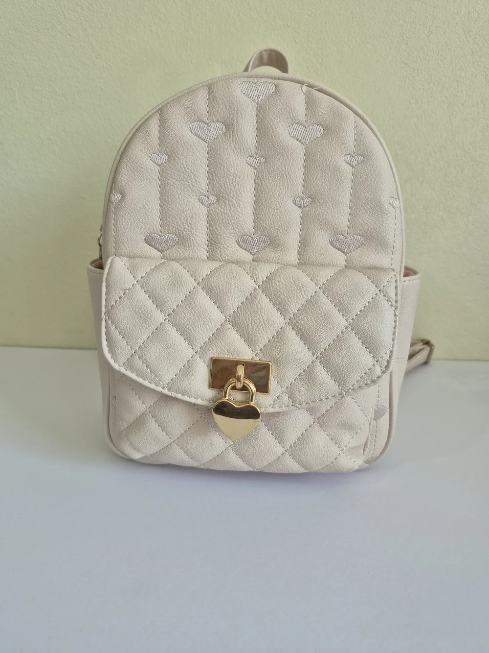 Under One Sky Cream Quilted Backpack with Gold Heart Lock